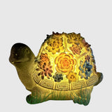 Sklenená záhradná lampa s dizajnom kvetinovej mušle a želvy